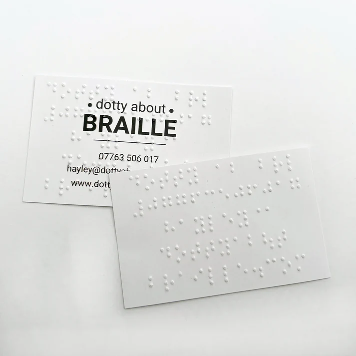 Business card in which which has the Dotty About Braille company details